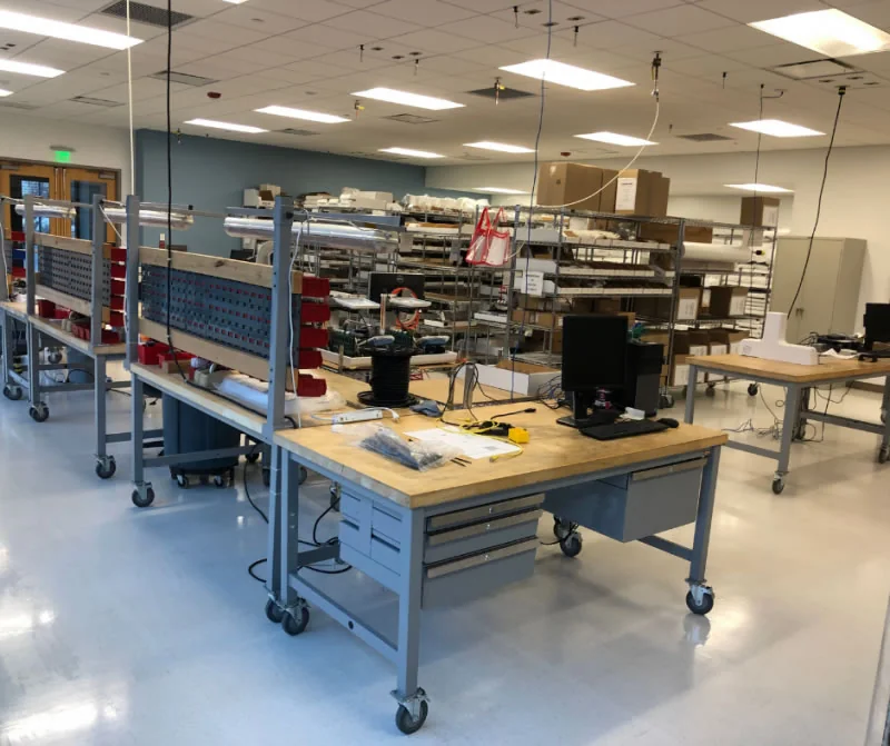 Industrial production workspace with workbenches and equipment.